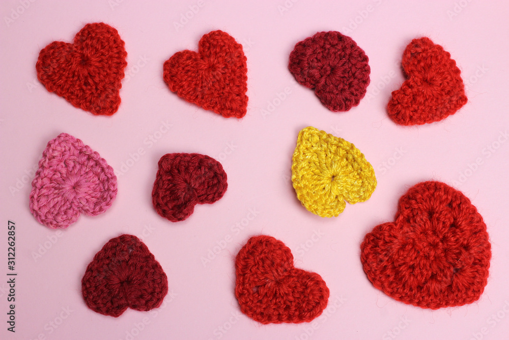 Knitted hearts on pink. Texture, background. Valentine's day Knitted hearts on pink. Texture, background. Valentine's day