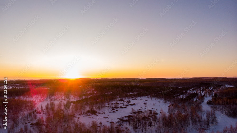 Winter forest, beautiful sunset, aerial view