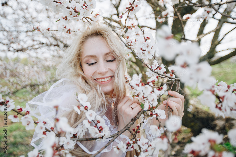 Spring smile. Happy beautiful smiling young woman in blossom park. Spring smile. Happy beautiful smiling young woman in blossom park.