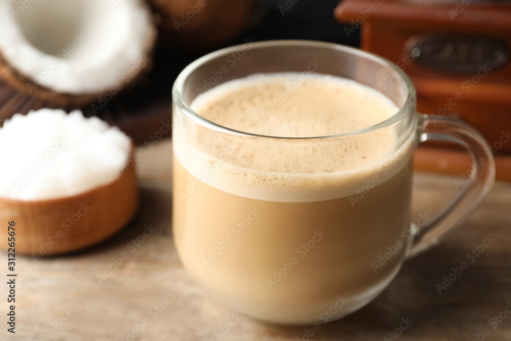 Delicious coffee with organic coconut oil on wooden table Delicious coffee with organic coconut oil on wooden table