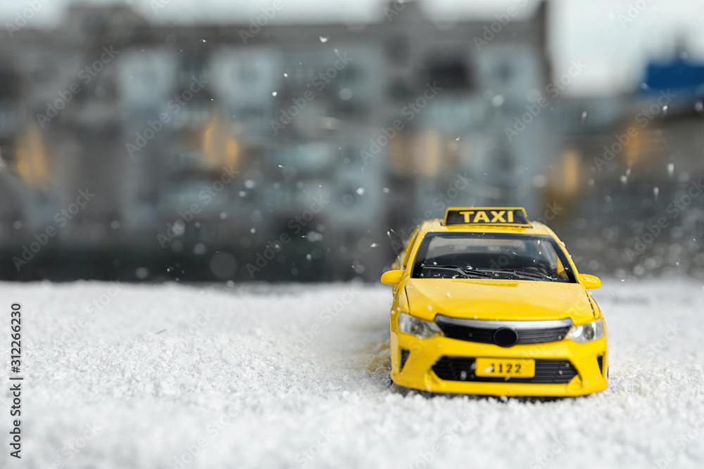 Yellow taxi car model on snow outdoors