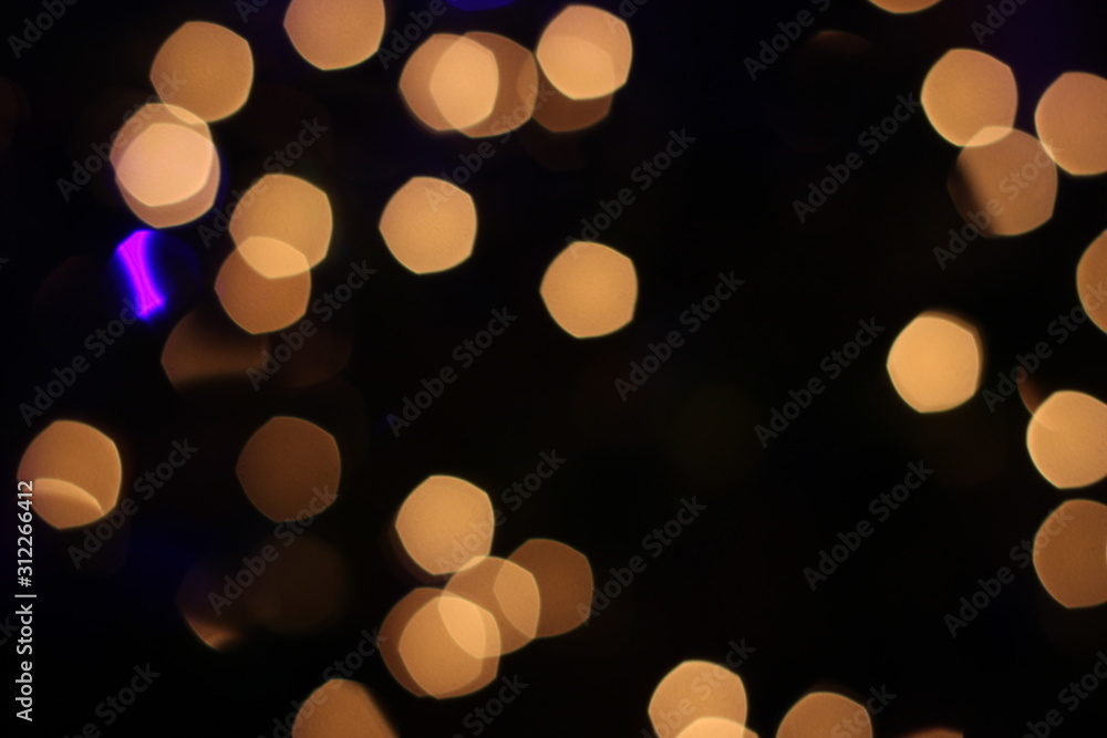 blurry yellow lights in pentagonal and circular shapes. Festive, background.