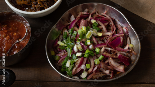 Freshly pickled red onion with spices and vinegar