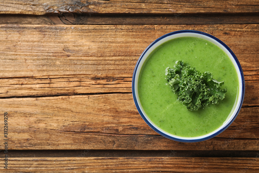 Tasty kale soup on wooden table, top view. Space for text Tasty kale soup on wooden table, top view. Space for text