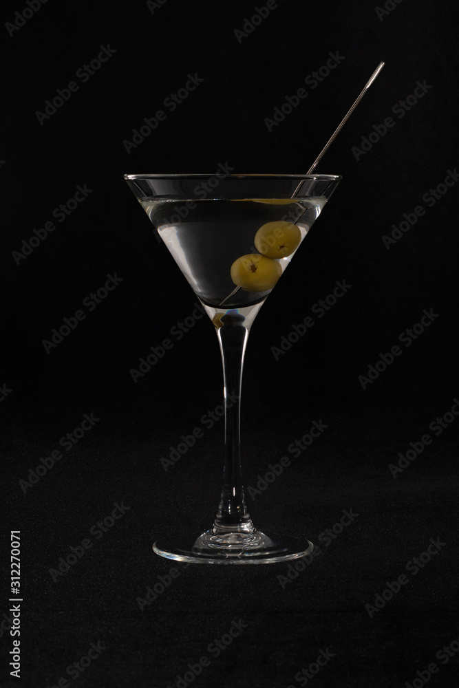 martini cocktail with olives in a transparent triangular glass