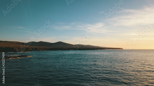 Landscape and sunset on the coast contemplating the breaking of the waves on the cliffs