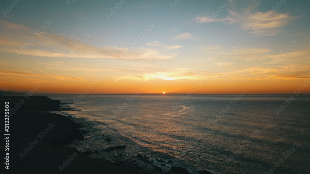 Landscape and sunset on the coast contemplating the breaking of the waves on the cliffs