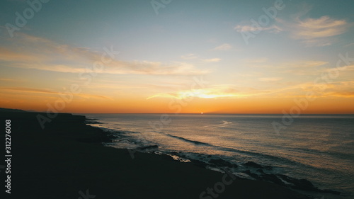 Landscape and sunset on the coast contemplating the breaking of the waves on the cliffs