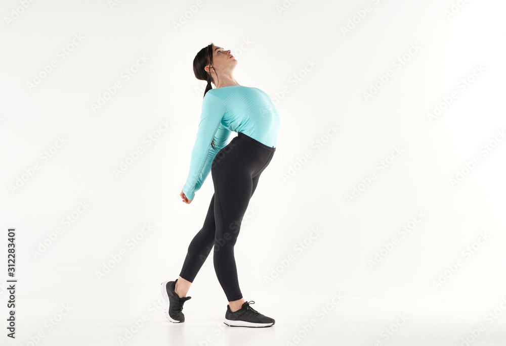 Obraz premium Young athletic woman making yoga and gymnastics stretching exercises isolated on white 