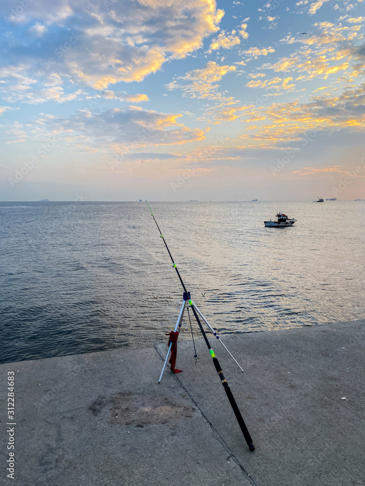 Fishermen fishing at sunset on the shores of the Sea of Marmara in Istanbul Turkey