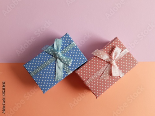 minimal gift boxes with ribbon and bow isolated on pastel background