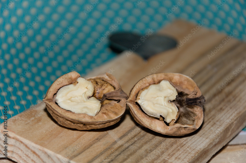Walnuts kernels and nutcracker on wooden table Walnuts kernels and nutcracker on wooden table