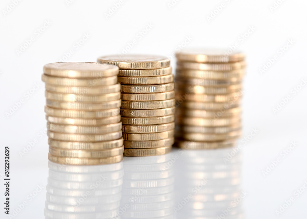 A stack of Australian one dollar gold coins set against a white background. A stack of Australian one dollar gold coins set against a white background.