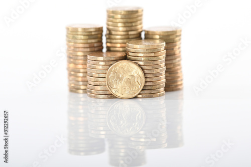 A stack of Australian one dollar gold coins set against a white background.