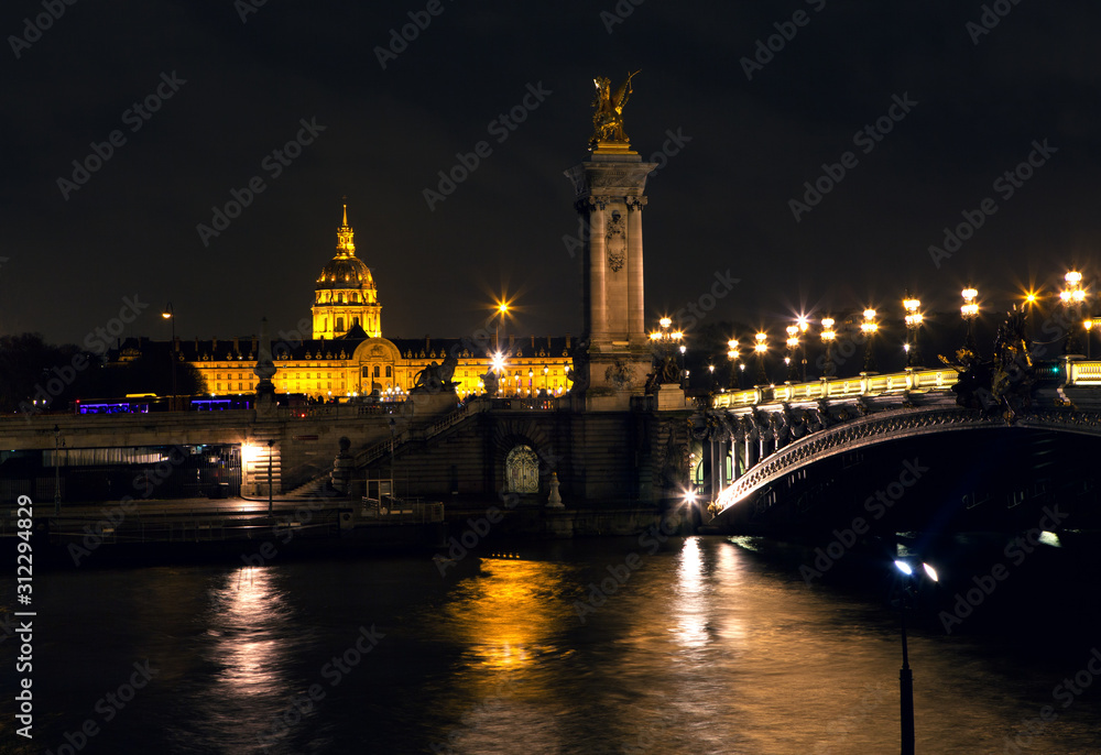 Night view of Seine river and Invalides in Paris 