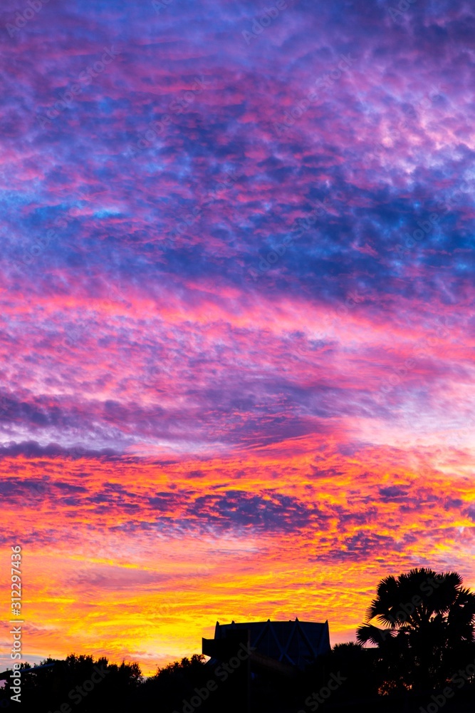 Multi color sunset over silhouette skyline