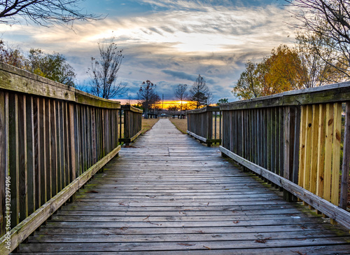 A wooden walkway and the setting sun 