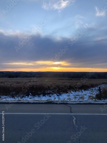 sunset over frozen lake