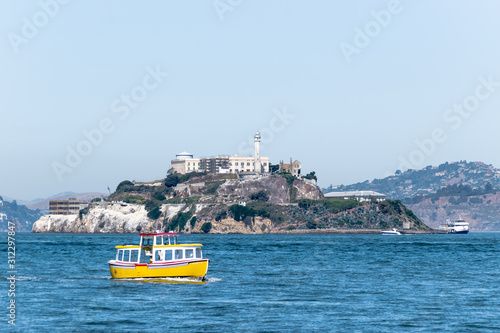 Alcatraz Prison Island in San Francisco Bay, offshore from San Francisco, a small island now national historic landmark with tourist tour boats approaching in San Francisco, California