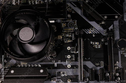 Close-up of a modern computer motherboard with installed cpu and cooler. Electronic computer hardware technology