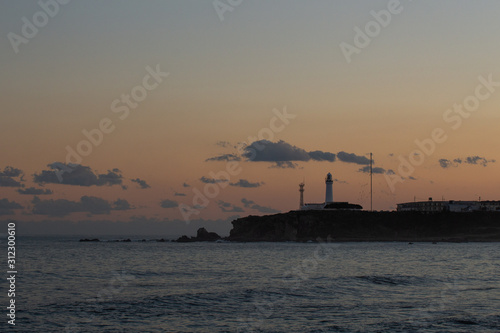 Sunset beach and a lighthouse © Tozzer