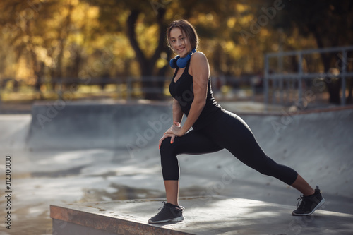 Fit woman in sportswear practicing aerobics at a sports park. Healthy lifestyle concept