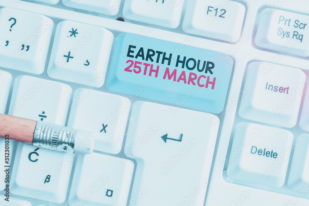 Writing note showing Earth Hour 25Th March. Business concept for symbol commitment to planet Organized World Wide Fund White pc keyboard with note paper above the white background Writing note showing Earth Hour 25Th March. Business concept for symbol commitment to planet Organized World Wide Fund White pc keyboard with note paper above the white background
