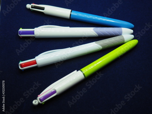 Four multicolored pens