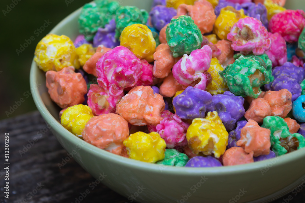 a blue bowl of bright rainbow popcorn a blue bowl of bright rainbow popcorn