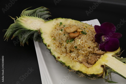 Fried rice in pineapple on white plate