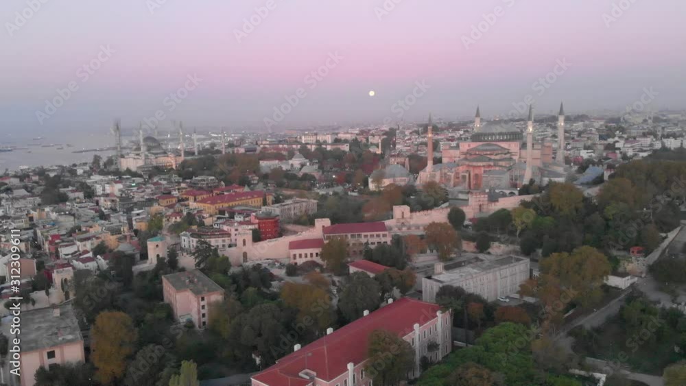 Hagia Sophia and the city of Istanbul, Turkey at sunset. Wide aerial view of the cityscape with shades of purple and blue sky horizon. Famous dome of popular museum former church and mosque. Hagia Sophia and the city of Istanbul, Turkey at sunset. Wide aerial view of the cityscape with shades of purple and blue sky horizon. Famous dome of popular museum former church and mosque.