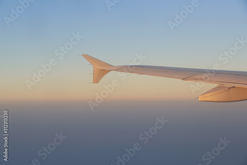 Beautiful sky during sunrise and airplane wing.
