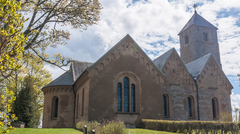 Fototapeta premium Cloudy sky over a church in central Sweden.