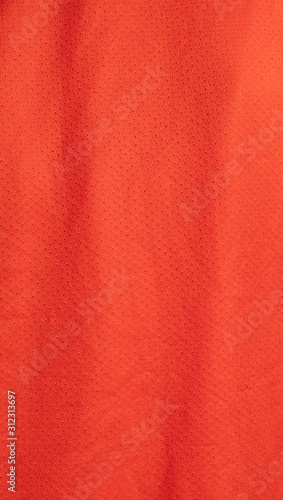 Dark red woven fabric texture pattern background. Closeup