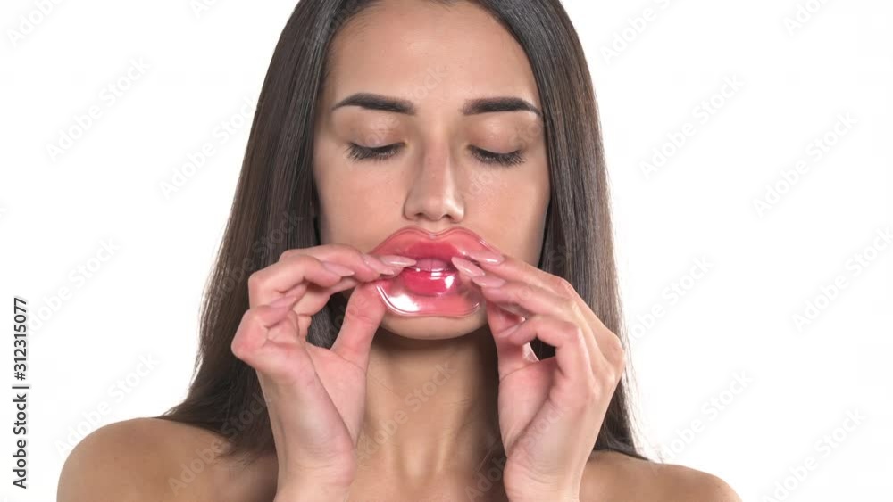 Close-up portrait shot of a beautiful woman using anti-aging collagen lips mask. Cosmetic product. Beauty and healthcare concept Close-up portrait shot of a beautiful woman using anti-aging collagen lips mask. Cosmetic product. Beauty and healthcare concept