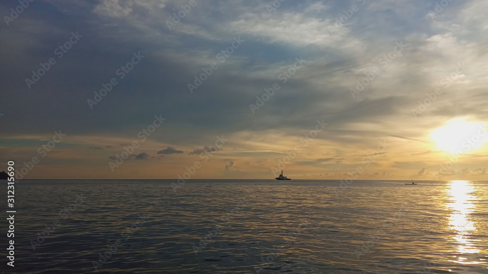 view The atmosphere of the sunset on the sea, with a boat