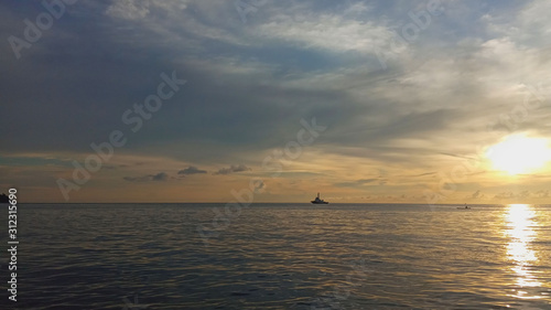 view The atmosphere of the sunset on the sea, with a boat
