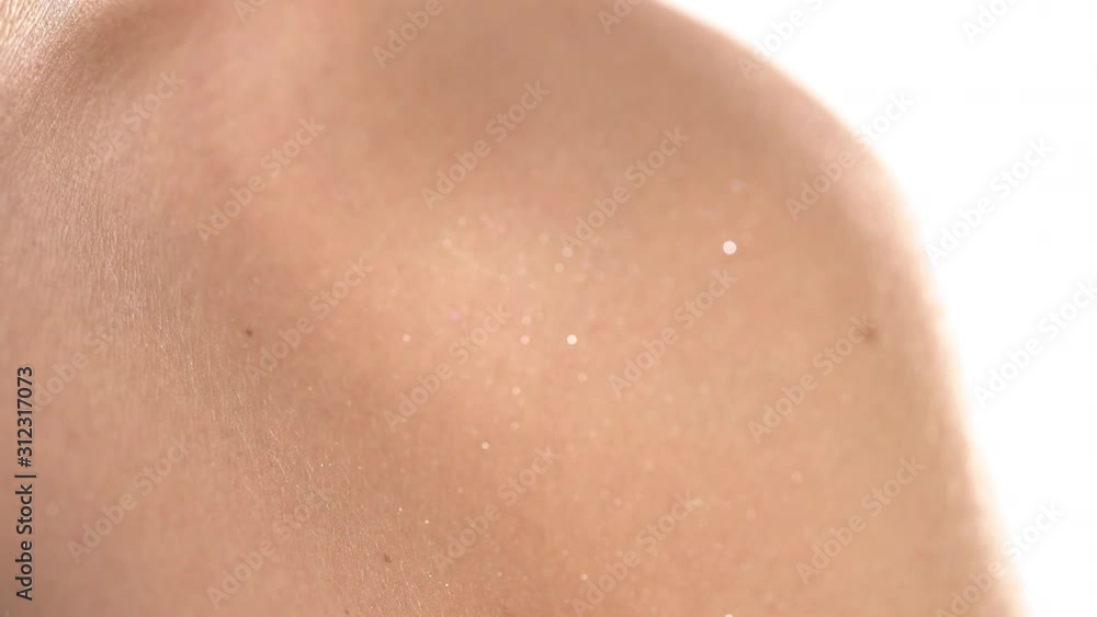 Close-up of silky female skin with sparkles. Body make-up. Beauty concept. Focus changing shot Close-up of silky female skin with sparkles. Body make-up. Beauty concept. Focus changing shot