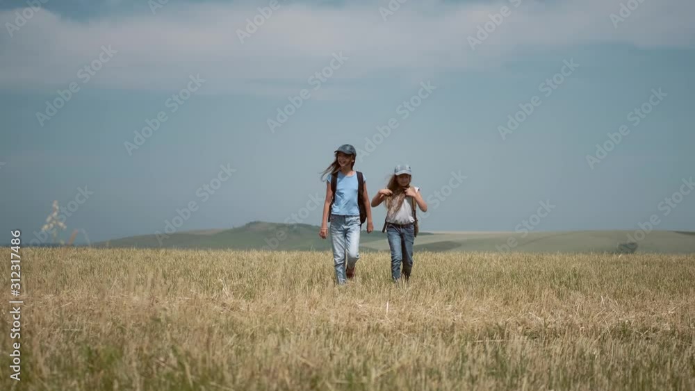 children travelers with backpacks go on a hike towards adventure children travelers with backpacks go on a hike towards adventure