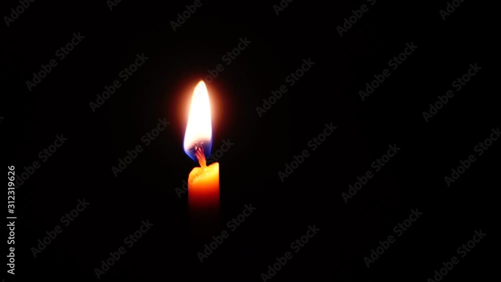 Flaring up a wax candle in complete darkness. Flaring up a wax candle in complete darkness.