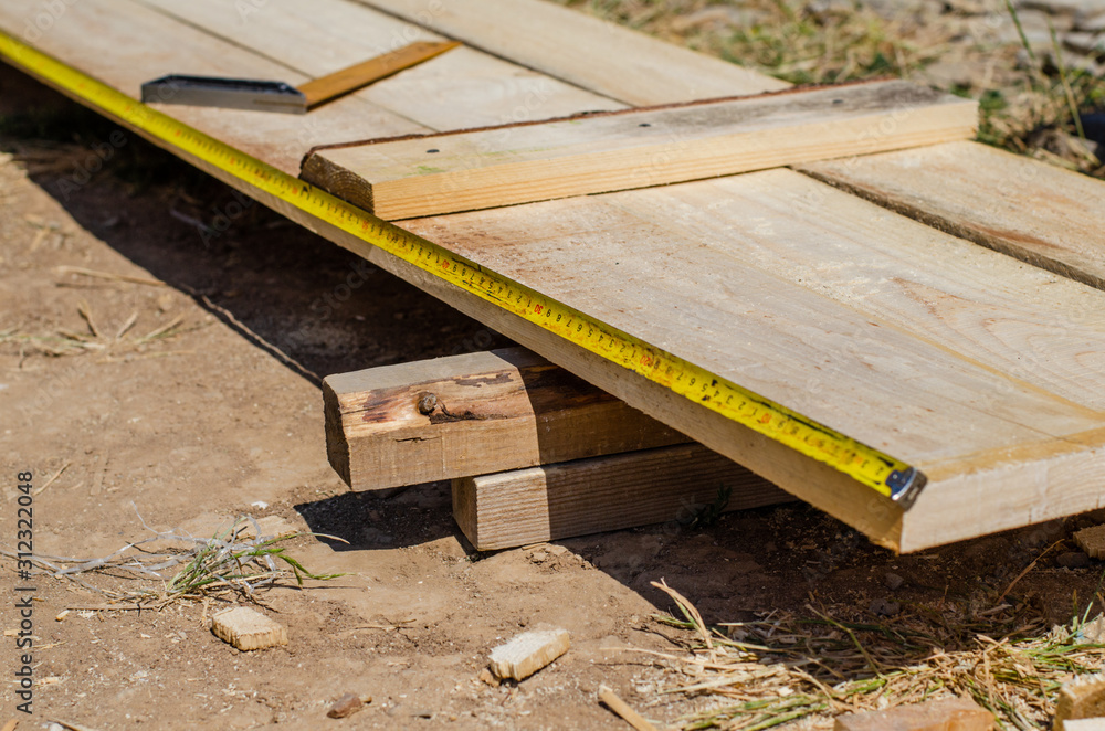yellow measuring tape measures the formwork boards yellow measuring tape measures the formwork boards