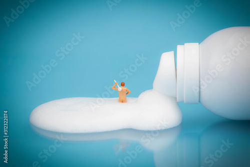miniature man taking a foam bath 