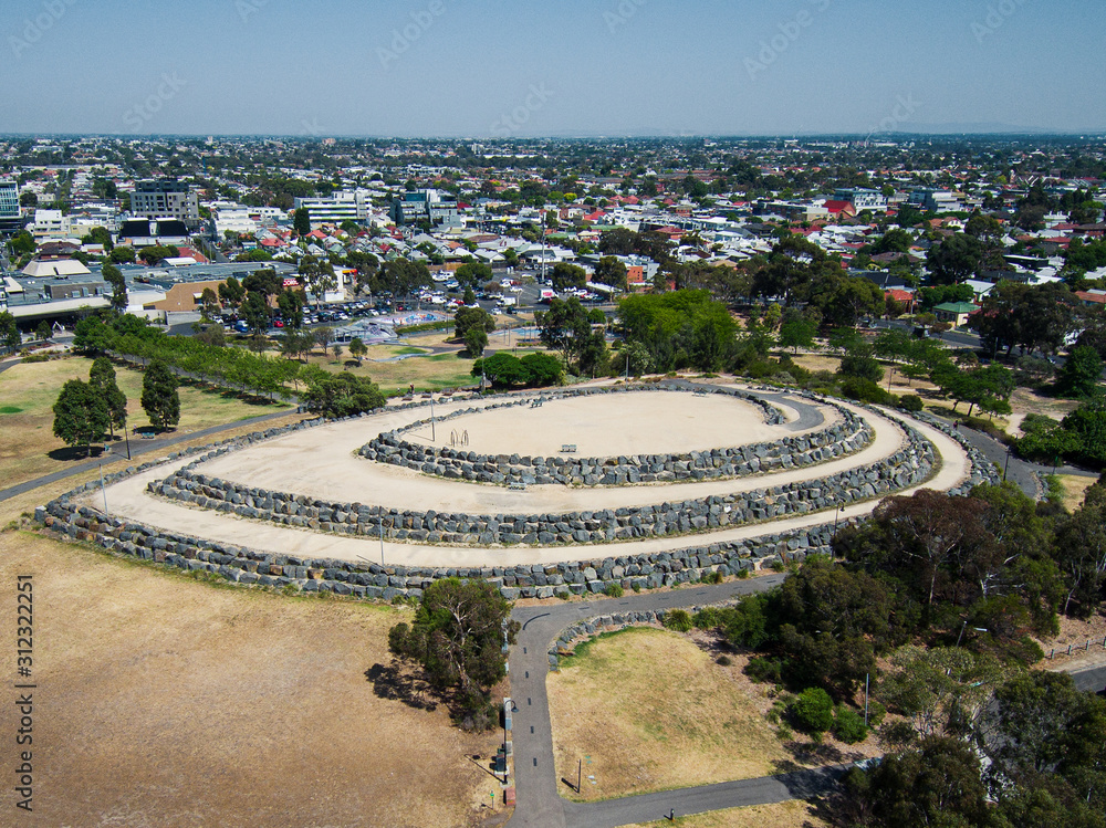 The Hilltop in the shape of a ship next to Veterans Walk and ANZAC Memorial on the site of the former Northcote Brickworks Quarry, viewed from above and the side in Melbourne, Victoria, Australia