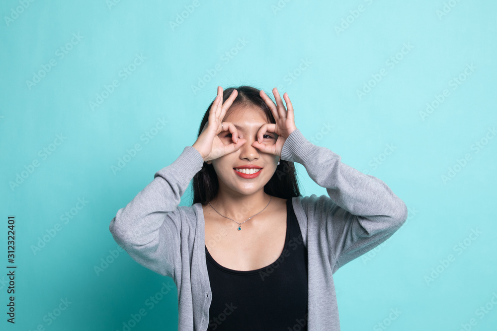 Asian woman do funny double OK sign as glasses. Asian woman do funny double OK sign as glasses.