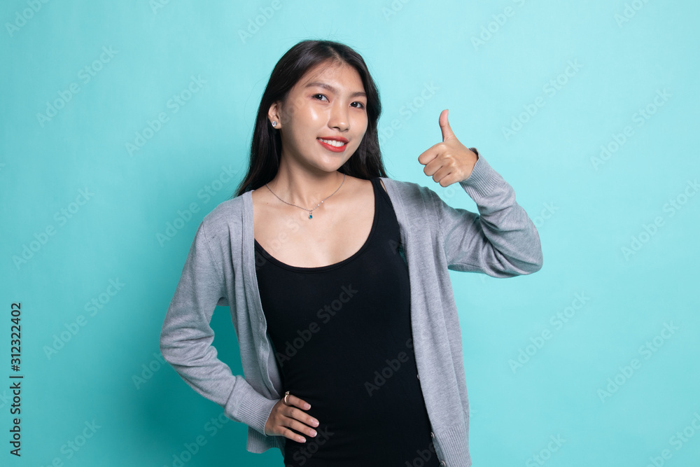 Young Asian woman show thumbs up. Young Asian woman show thumbs up.