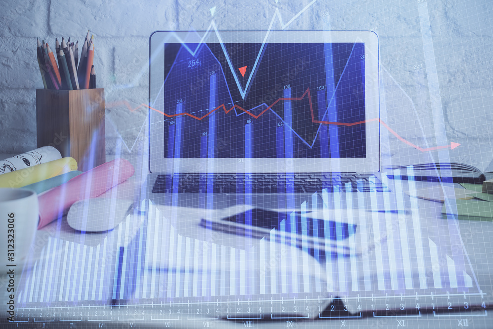 Financial chart drawing and table with computer on background. Double exposure. Concept of international markets. Financial chart drawing and table with computer on background. Double exposure. Concept of international markets.