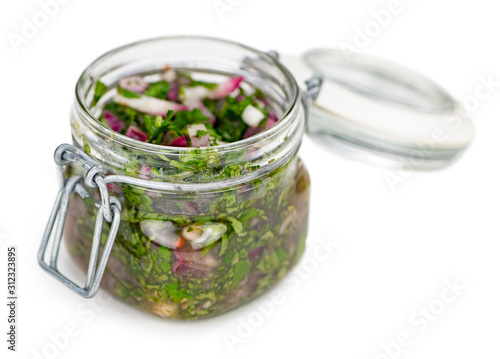 Some Homemade Chimichurri isolated on white (selective focus)