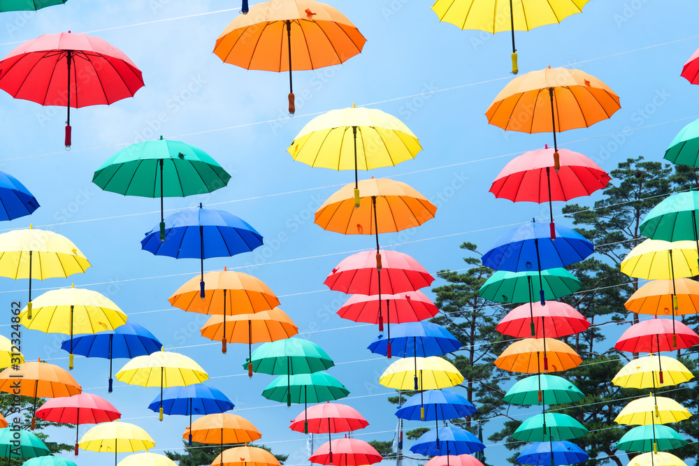Colorful umbrellas background. Multicolored umbrellas hanging above the street. 