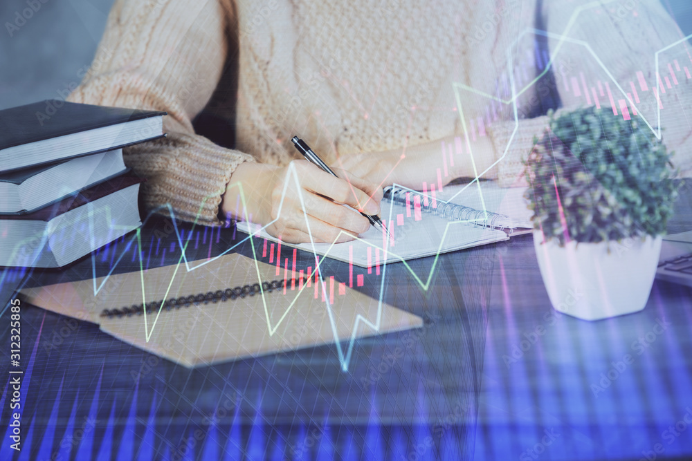 Forex graph on hand taking notes background. Concept of research. Double exposure Forex graph on hand taking notes background. Concept of research. Double exposure