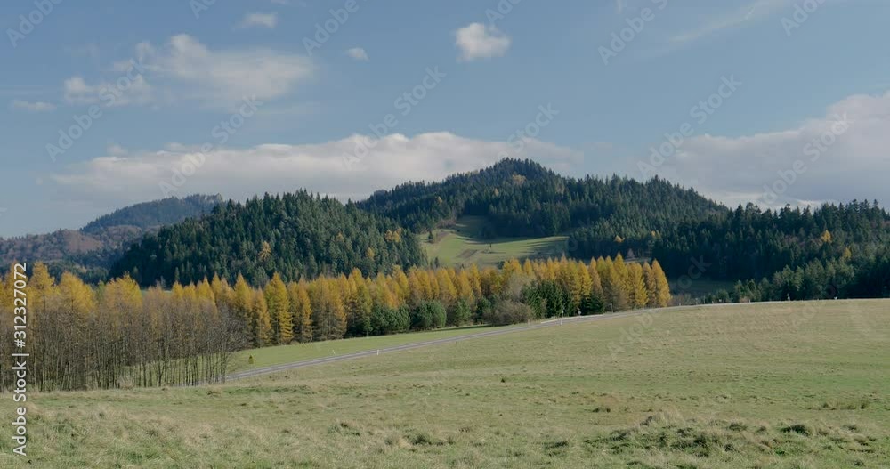 Timelapse over forest road and rolling hills. Timelapse over forest road and rolling hills.